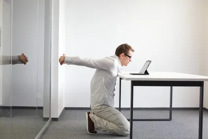 exercise during office work - man with tablet in his office